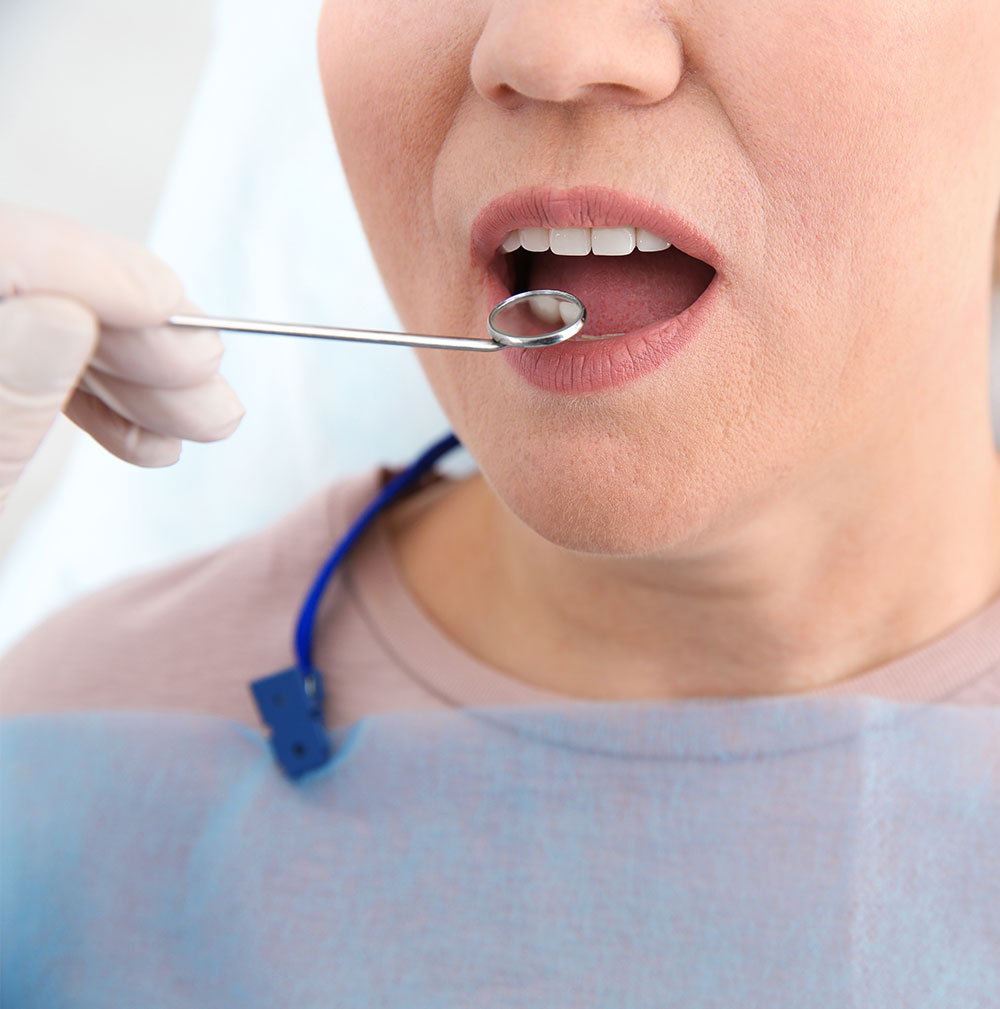 close up of woman being screened for oral cancer