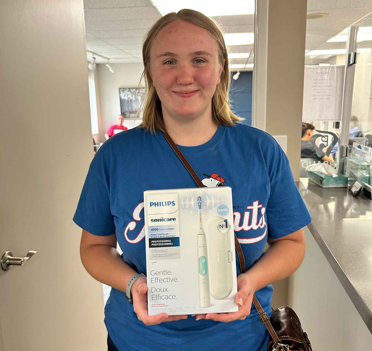 Chelsea holds her new electric toothbrush