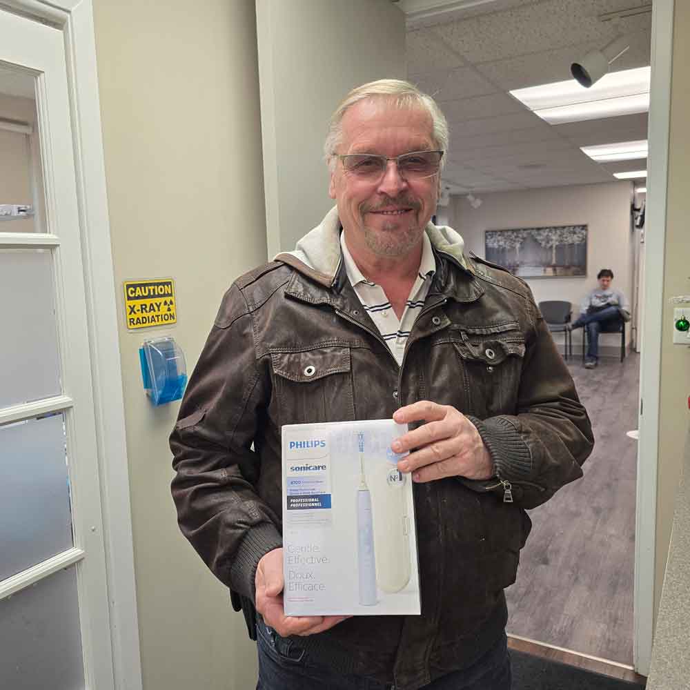 Steve holds his new Phillips electric toothbrush